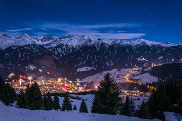 New Years Eve fireworks over village Fiss in Austria with snowy mountains