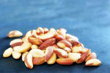 Brazil nuts on dark slate background, selective focus.