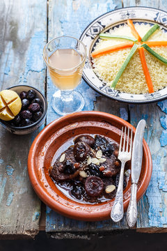 Traditional moroccan dishes: beef tajine, couscous, olives and salted lemons. Rustic style
