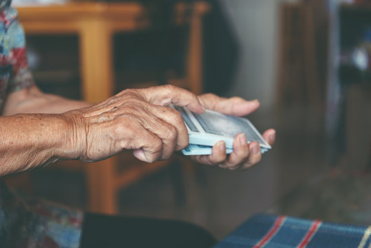 Active Retirement, Old People And Seniors Free Time, Selected Focus On Old Women Wrinkle Hands Having Fun And Playing Cards Game At Home.