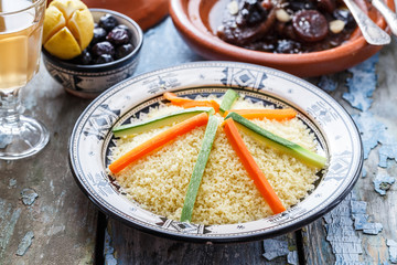 Moroccan couscous topped with vegetables. Rustic style.