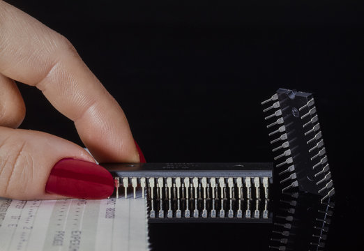 Two microchips holding it with the fingers of the hand