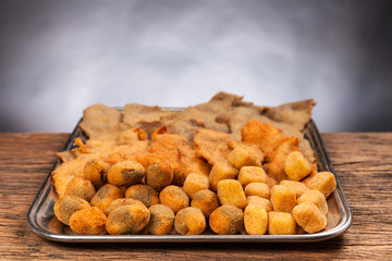 Italian food. Fried cream and olives ascolane . Typical regional dish. Wooden table, black background