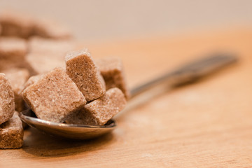 Close up of Brown sugar cubes with spoon