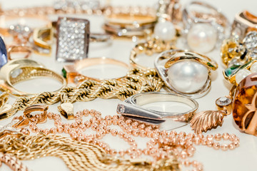 Close up of pile of jewelry on white background
