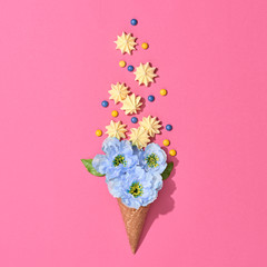 Ice Cream Cone with Candies Sweets. Meringue, Blue Flowers. Spring Summer Party, Birthday concept. Pink Vanilla Color. Trendy fashion Style. Minimal. Vintage