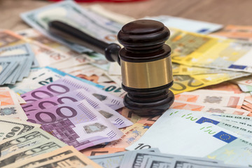 Judge gavel on dollars and euro banknotes