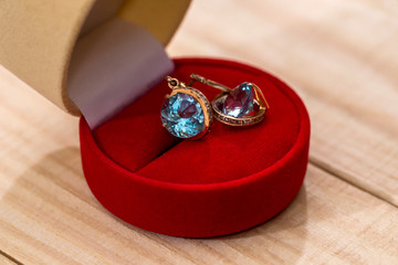 Gold earrings with crystal in a gift box