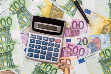 euro with pen and calculator. close up