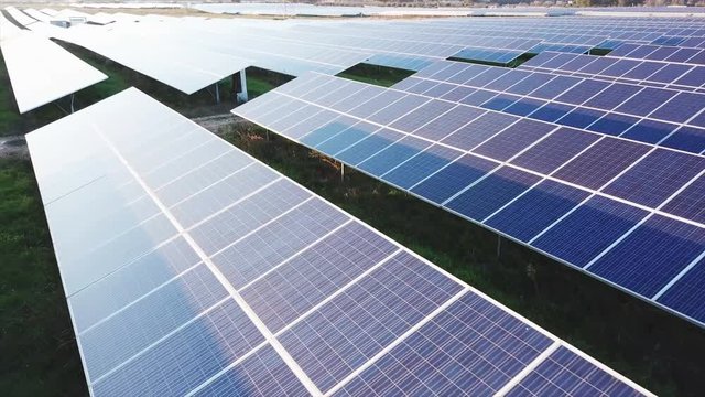 solar panels at sunset, aerial view from 4k drone
