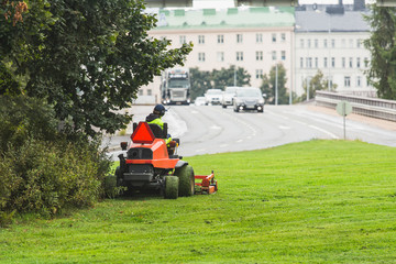 A man mowing a lawn on a tractor