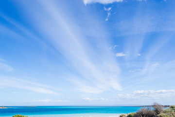 Blue sky with clouds over La Pelosa beach