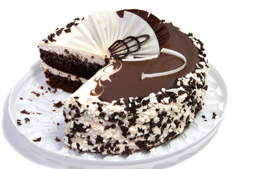 Chocolate cake decorated with butter cream with condensed milk on light background