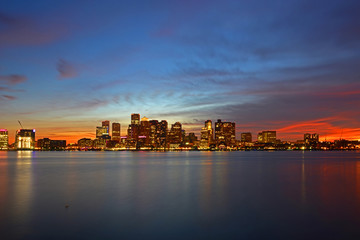Naklejka premium Boston City Skyscrapers, Custom House and Boston Waterfront at night from East Boston, Boston, Massachusetts, USA.