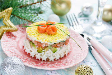 Delicious and beautiful layered salad with salted salmon, avocado, boiled egg and rice