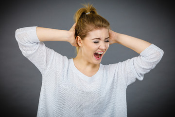 Unhappy woman screaming and yelling in pain