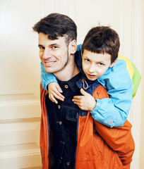 young handsome father with his son fooling around at home, lifes