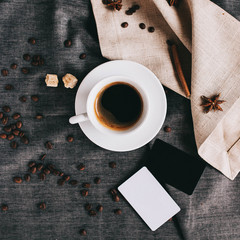 beautiful layout: coffee, cinnamon sticks and coffee beans on gray textiles