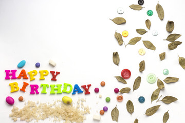 happy birthday with candy and colorful button and green leaf