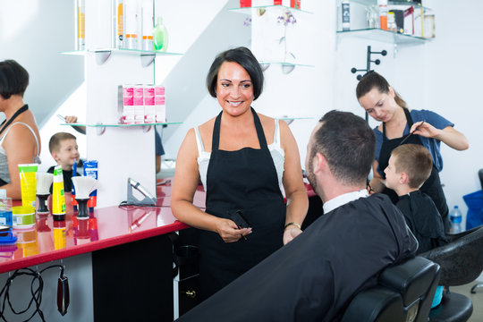 hairdresser and client in beauty salon .