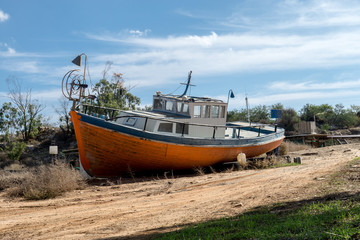 orange boat on shore 