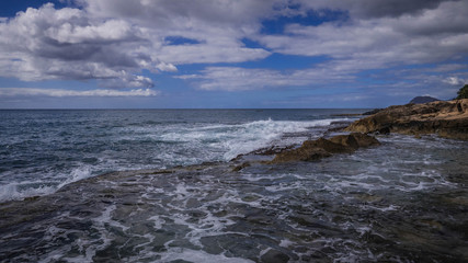 Waves Crashing against rocks on the Hawaiian coastline