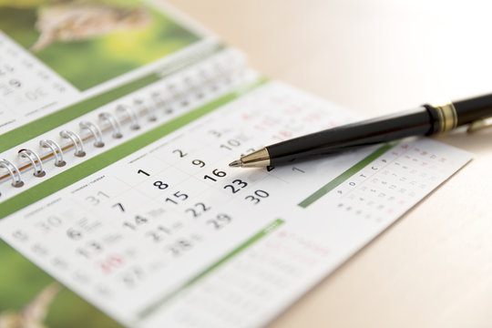 An Image of a calendar and a pen
