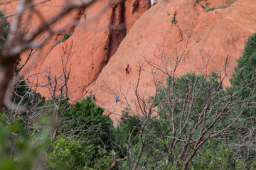 Distant red rock climber mountain climbers