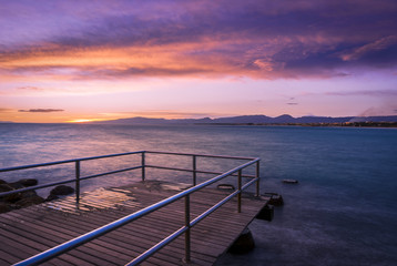 Fototapeta premium Blue Hour: Colorful dark sunset over the sea with a old pier on the foreground. Slow shutterspeed