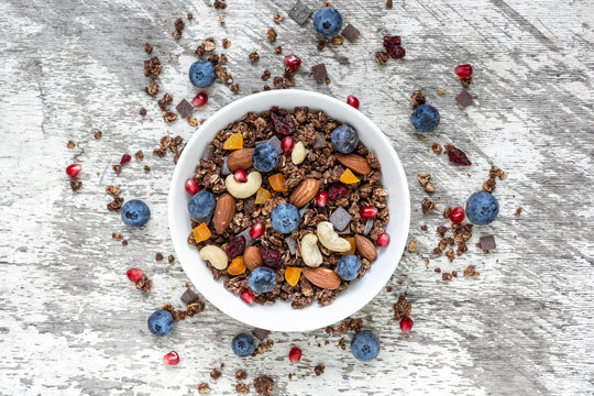 homemade chocolate muesli or granola with berries, dried fruits and nuts