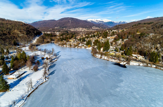 Aerial view of winter landscape of frozen lake Ghirla in province of Varese, Italy