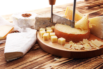 various types of cheese on rustic wooden table. cheese platter