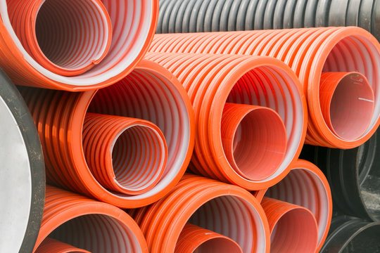 Construction orange and black plastic pipes