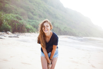 Pretty female smiles happily and laughs.