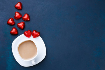 Breakfast at Valentine's Day. Cup of coffee with heart shaped chocolates, flat lay with copy space