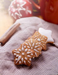 Fototapeta na wymiar Still life with cup of coffee or cacao, Apples and gingerbread cookies with icing sugar decoration. Winter holidays background