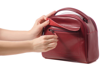 Red burgundy leather bag in female hands