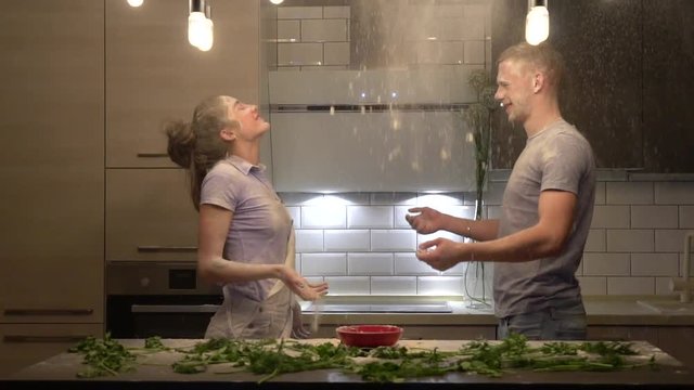 young couple flinging flour