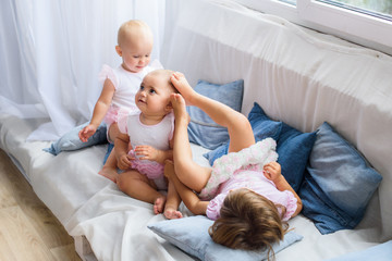 pretty three girls at home - three sisters are playing together