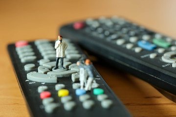 Miniature people : journalists , cameraman ,Videographer at work shooting on remote