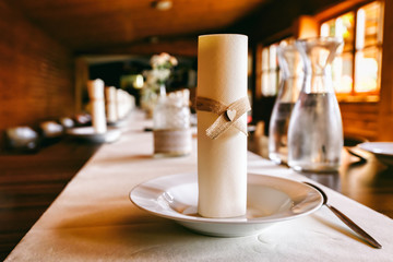 Dining table decorated with wedding decoration on the table, some decorations made of burlap