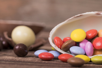 Chocolate Easter eggs and sweets on brown background