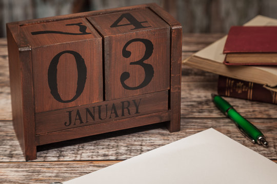 Perpetual Calendar in desk scene with blank diary page, January 3rd