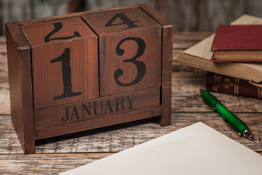 Perpetual Calendar in desk scene with blank diary page, January 13th
