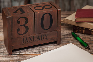 Perpetual Calendar in desk scene with blank diary page, January 30th