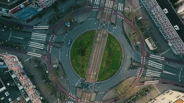 Aerial top down view time lapse of roundabout traffic in Amsterdam, Netherlands