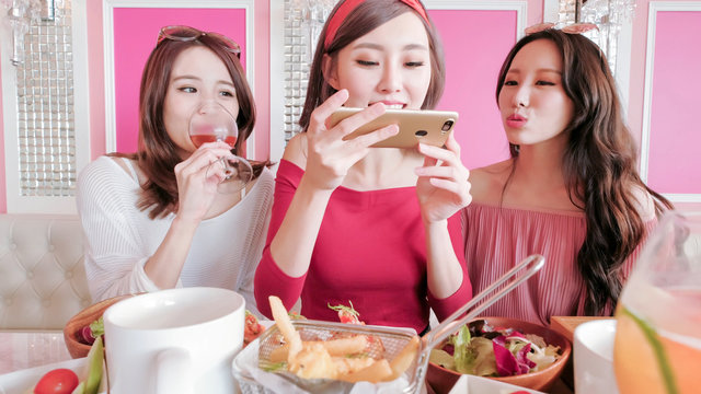 women take picture in restaurant