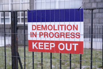 Demolition in progress keep out sign at construction building site