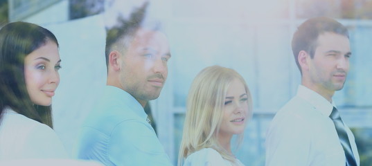 Happy smiling business team looking through window