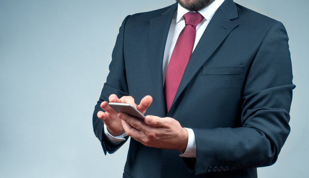 Businessman in suit using smartphone